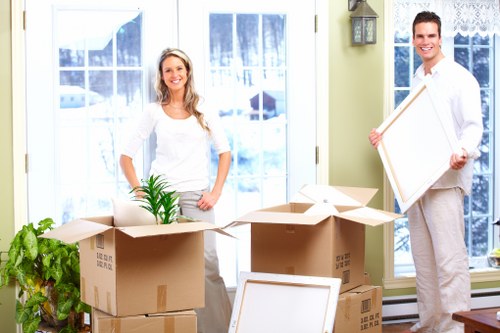 Professional movers handling boxes and household items in St Helier