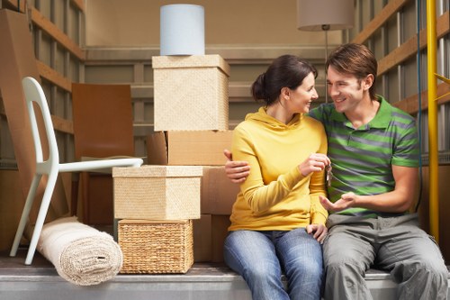 Professional movers handling furniture in a local St Helier property